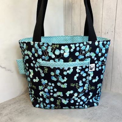 mini tote bag with light blue eucalyptus leaves on black background