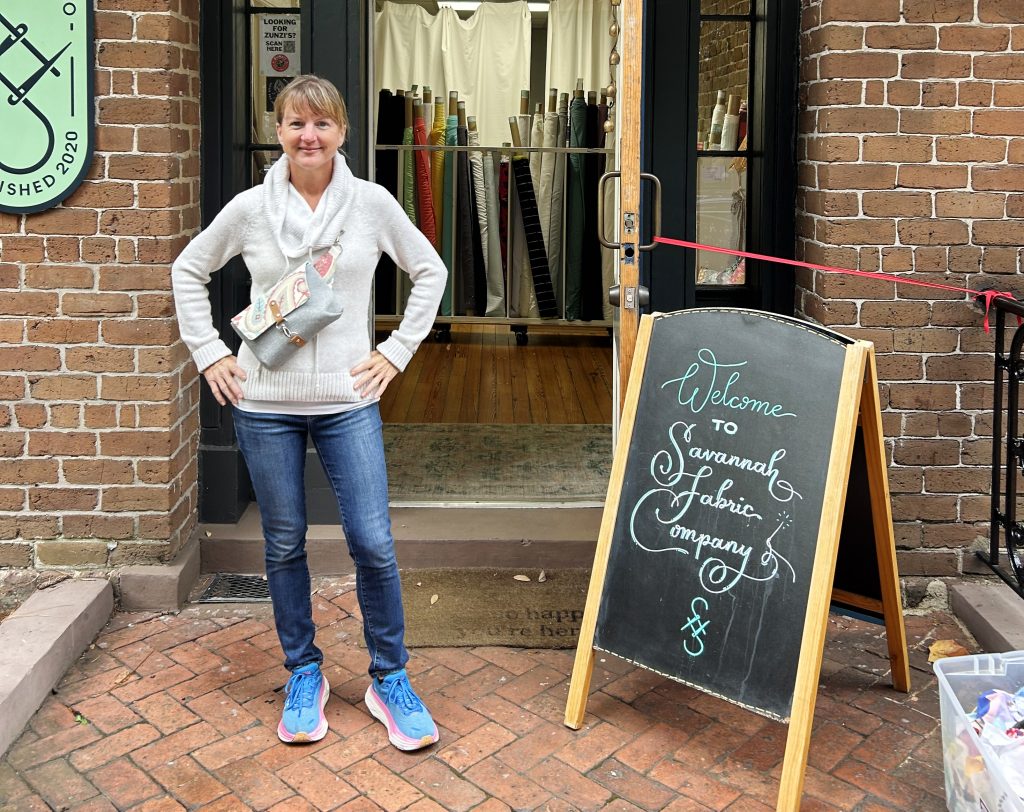 photo of Kim in front of savannah fabric shop
